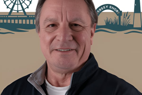 Man smiling at camera with Jersey Shore illustration background featuring Ferris wheel and lighthouse